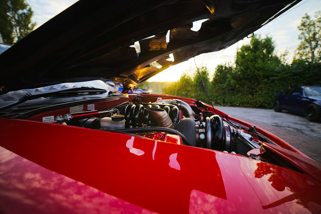 Mechanic working under the hood of a car